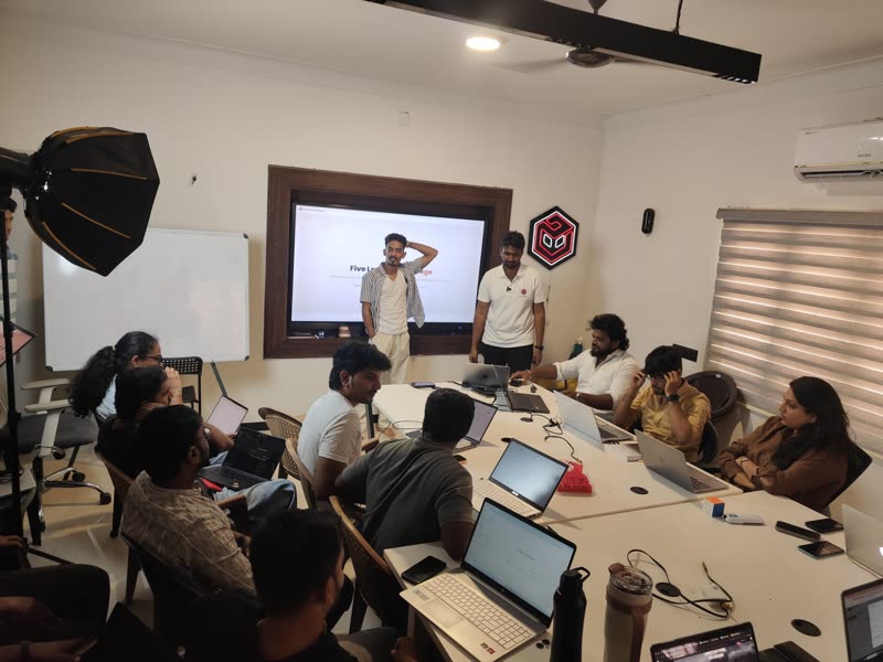 The Forgemind AI team working with laptops at the office